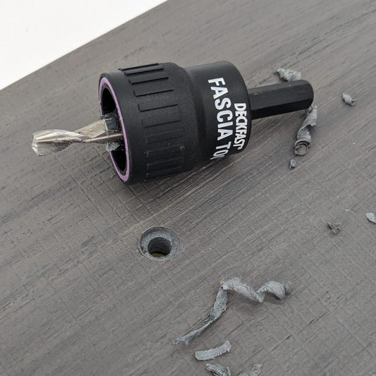 Starborn fascia tool drilling a pilot hole in grey fascia board