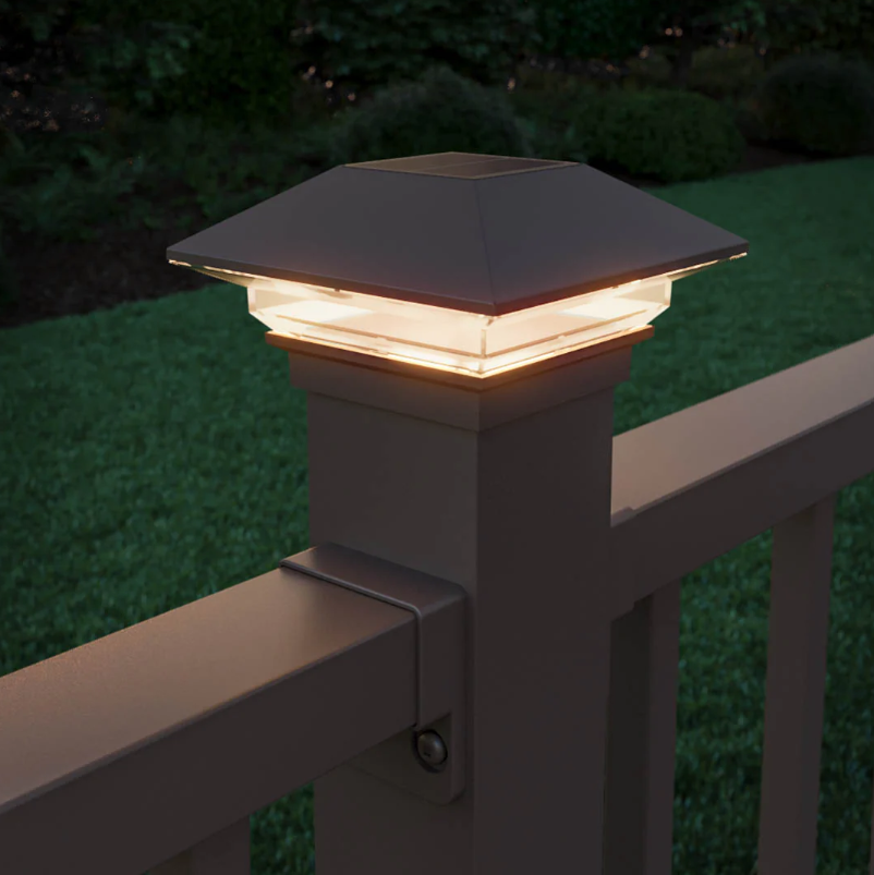 Deckorators Classic solar post cap in Weathered Brown, lit at dusk