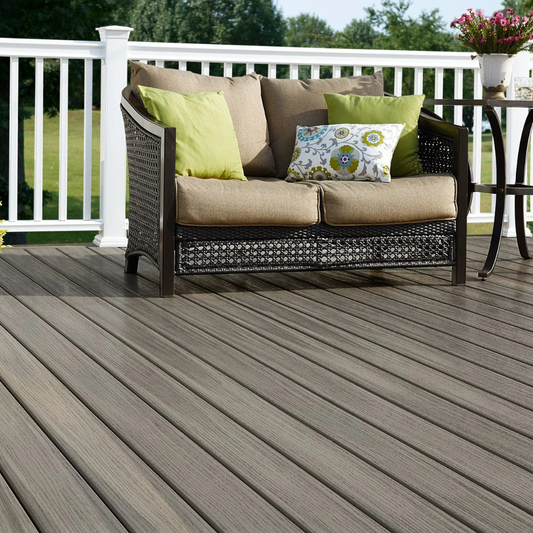 Grey Fiberon Paramount deck with white railing and a wicker loveseat