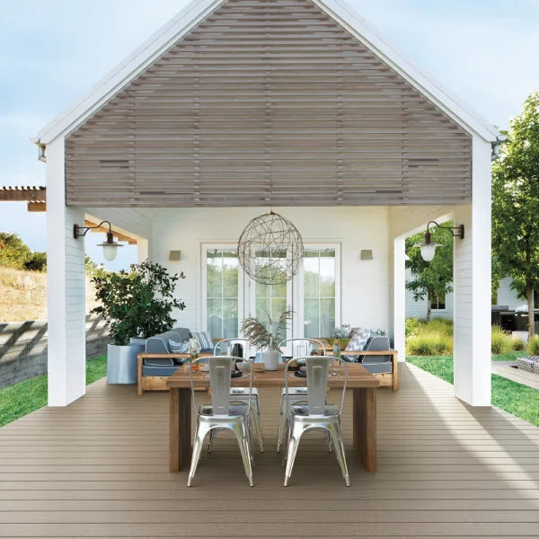 Fiberon Promenade deck featuring an outdoor dining area, modern farmhouse design, and scenic backyard views.