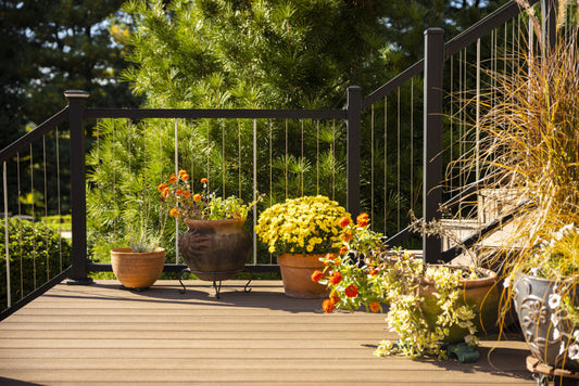 Deck with Keylink black vertical cable railing and potted flowers