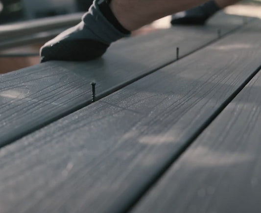 Ninja hidden deck clips installed between grey composite deck boards