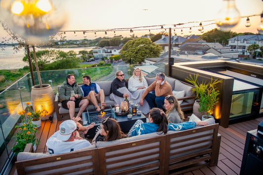 Friends gathered on a Trex Signature Ocracoke deck with string lights