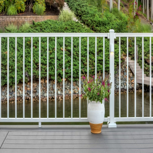Deck with white Trex Signature aluminum railing overlooking a garden