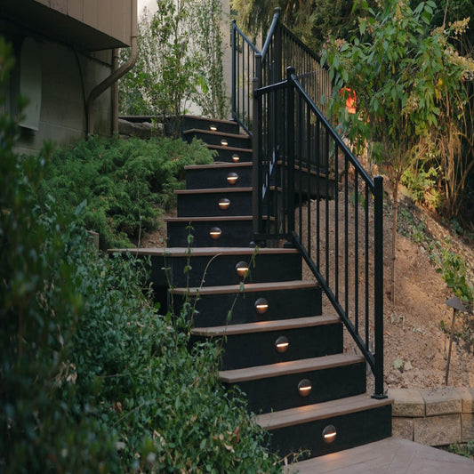 Hillside deck stairs with black Westbury railing and step lights