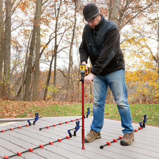 Installer standing on a deck using the FastenMaster Zip Stick