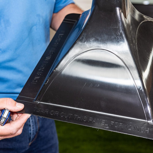 Person holding a Trex RainEscape downspout, underside view