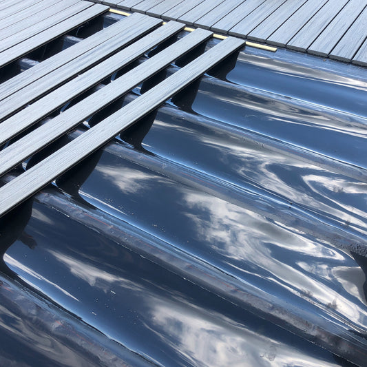 Trex RainEscape troughs installed between deck joists