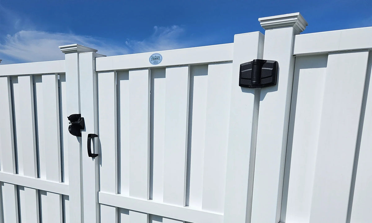 White vinyl fence with black gate hardware