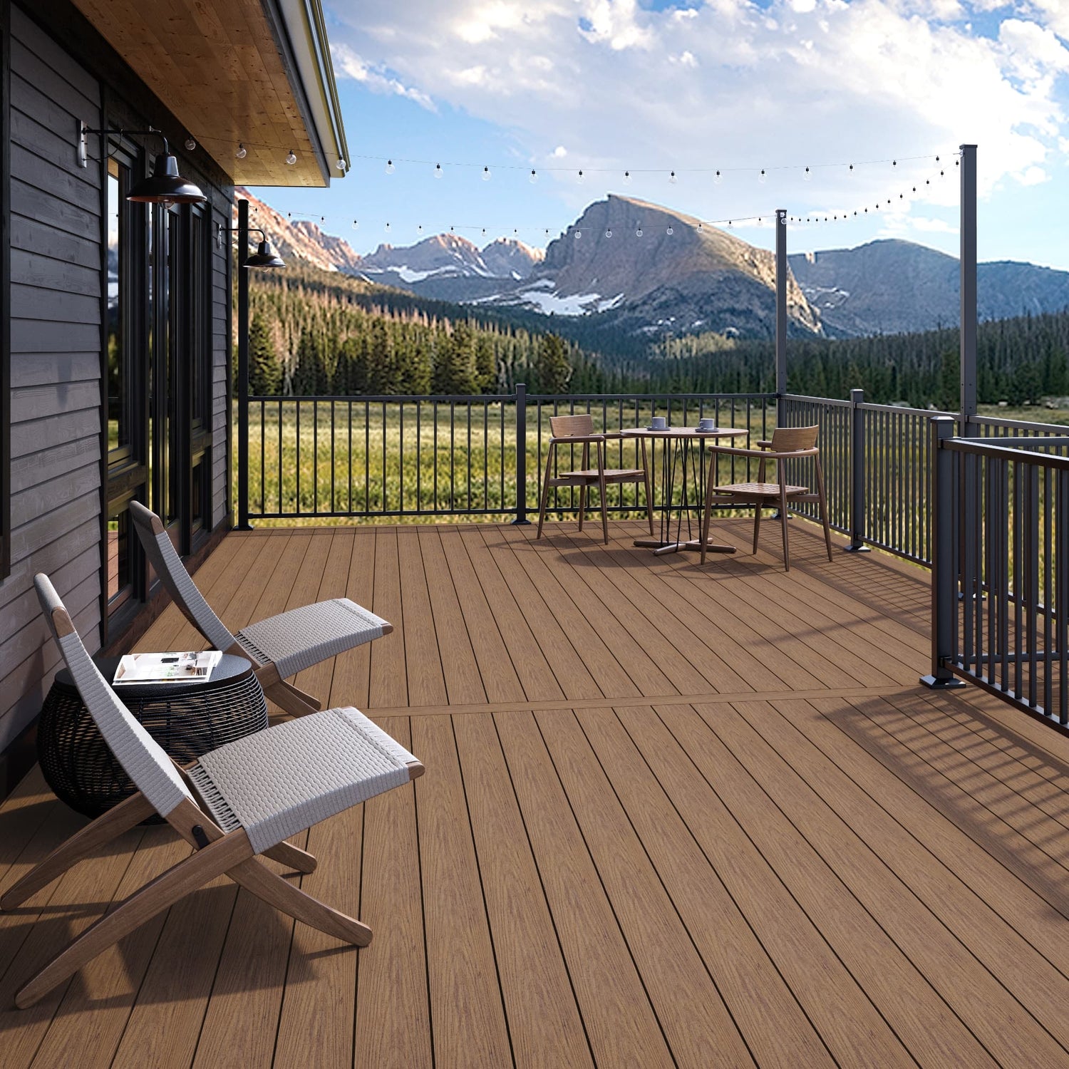 Wooden deck with chairs and a table, overlooking a mountainous landscape.