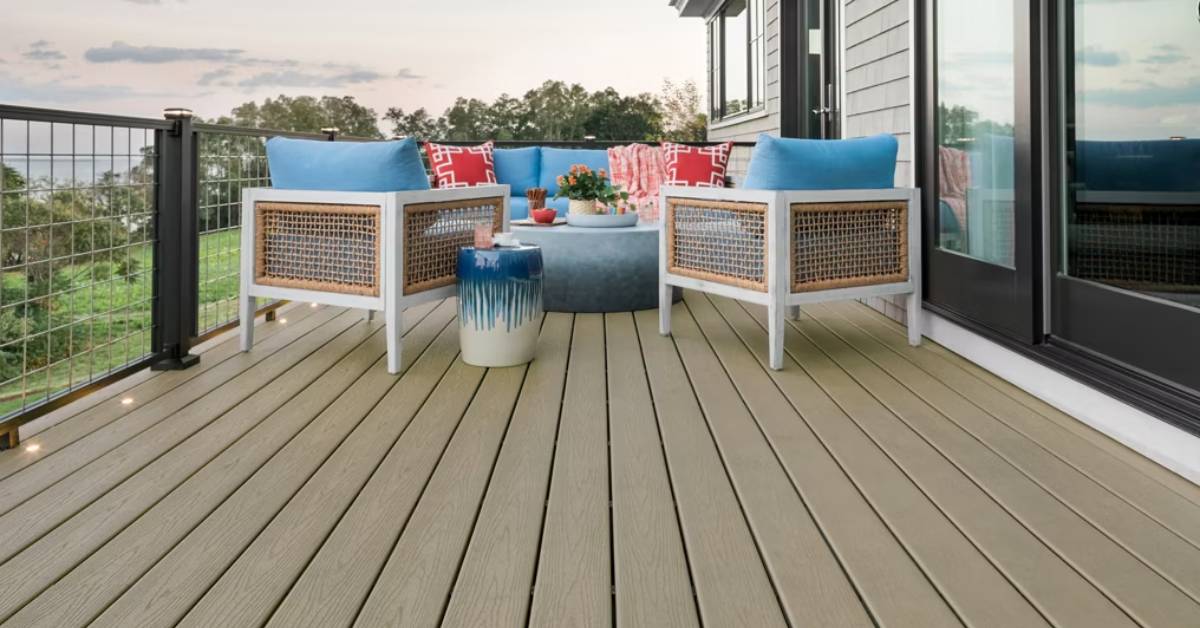 Outdoor seating area on Trex Transcend decking, featuring wicker chairs, blue cushions, and a decorative side table