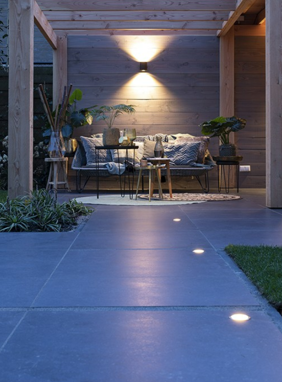 Outdoor patio area with seating and lighting