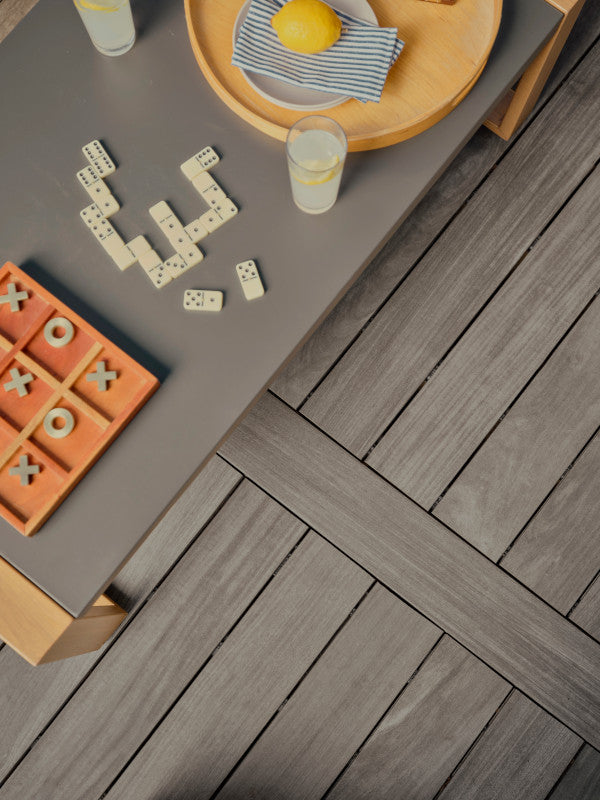 Outdoor table with games and drinks on a wooden deck