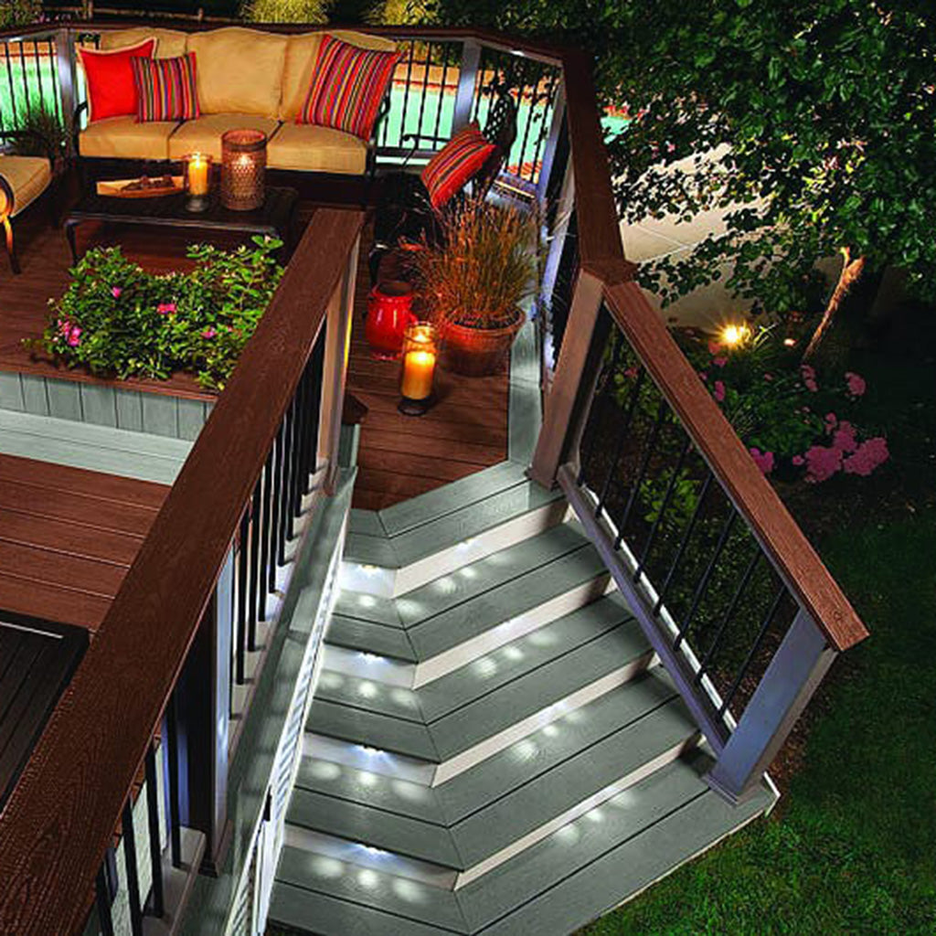 Trex Transcend deck featuring illuminated stairs, seating area, built-in planters, and colorful accents.