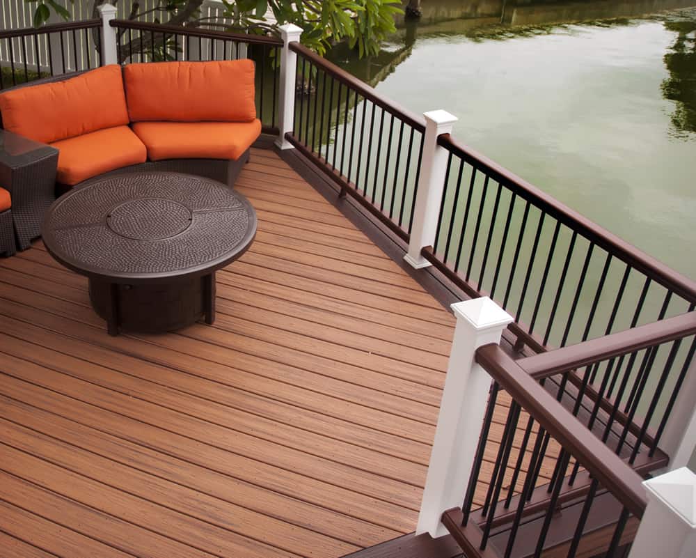 Trex deck with black railing and white posts, featuring outdoor seating.
