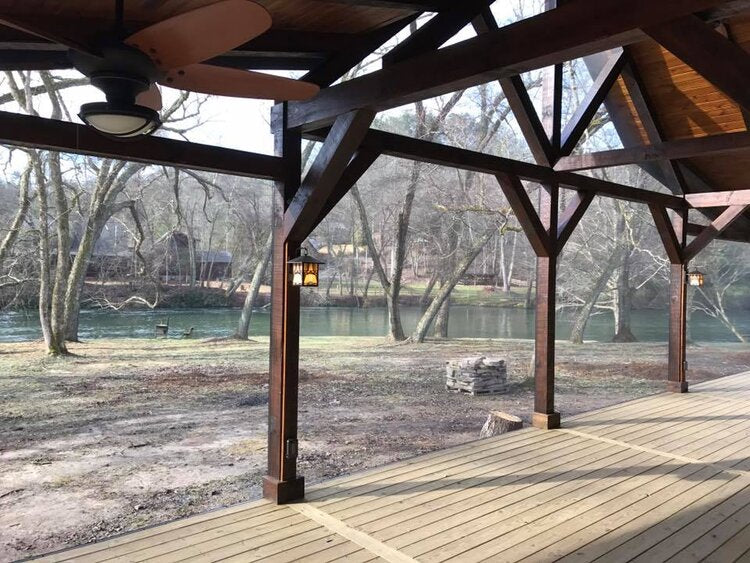 Wooden deck with a view of trees and water