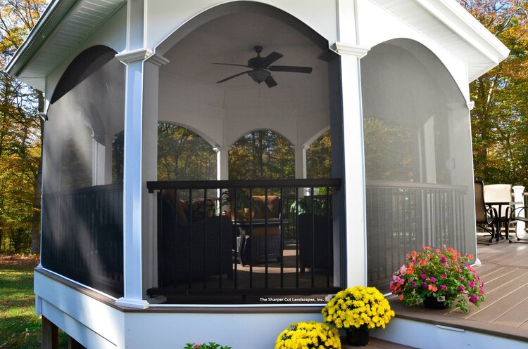 Gazebo with a screened-in porch, ceiling fan, and potted plants on a wooden deck.
