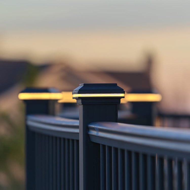 Black solar fence post lights on a blurred outdoor background