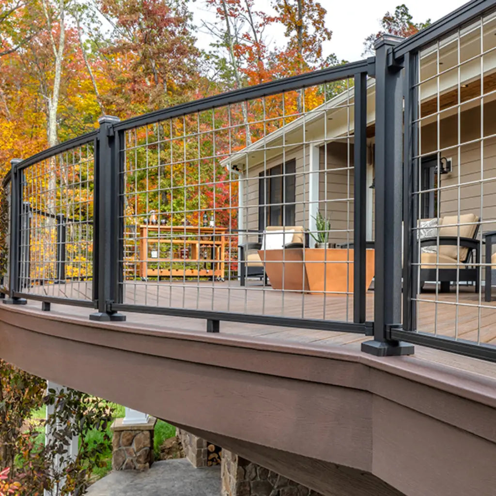 Deck featuring Trex fascia boards and wire railing system, with vibrant autumn foliage in the background