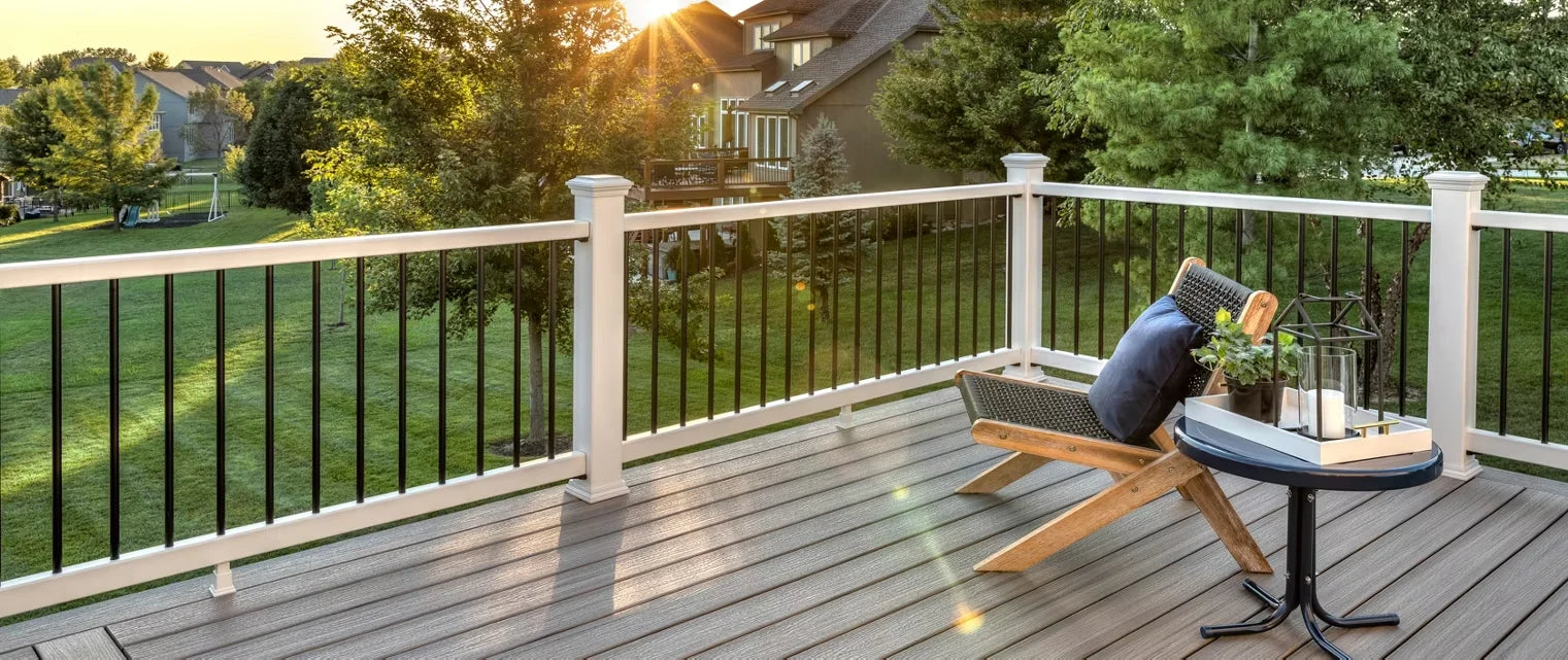 Outdoor deck featuring Trex Select railing with black balusters, a lounge chair, and a side table