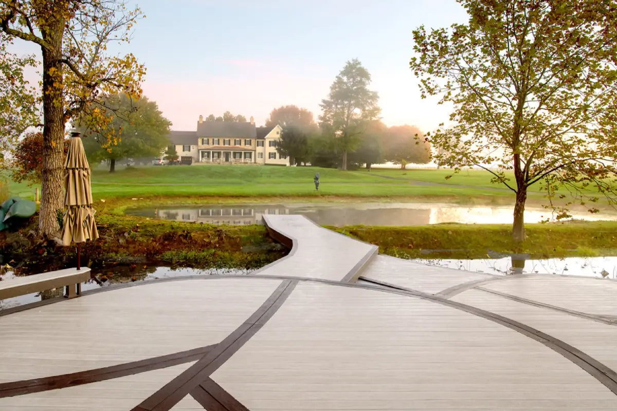 outdoor seating area designed with moisturshield vision composite deck boards near a pond
